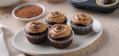 tray with chocolate cupcakes and peanut butter frosting.