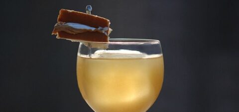 a glass of bourbon with a fluffernutter for garnish.