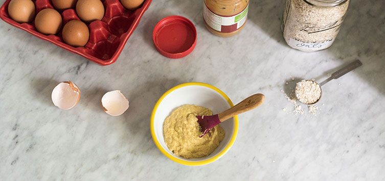 a table topped with eggs and a bowl of oatmeal.