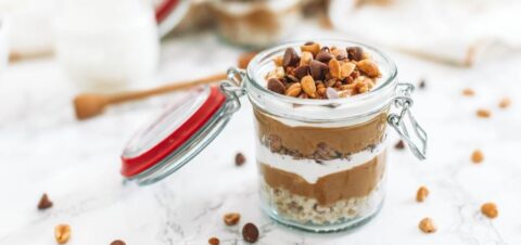 a glass jar filled with layers of granola