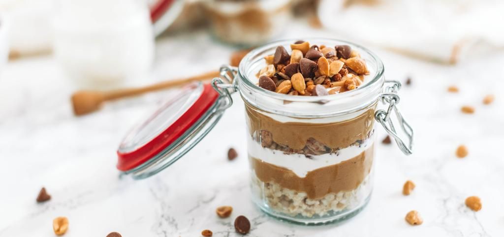 a glass jar filled with layers of granola