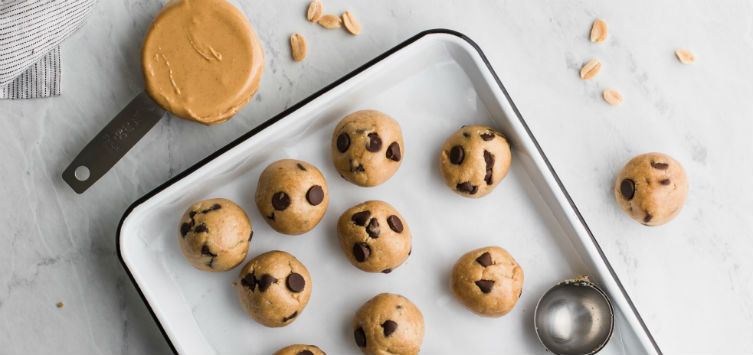 a tray of peanut cookies with chocolate chips before going to the oven.