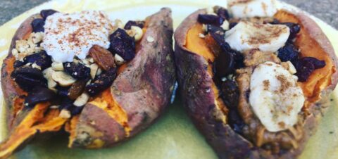 two big sweet potatos baked and cut in half stuffed with nuts and fruits.