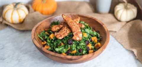 chicken fillets on top of a salad bowl.