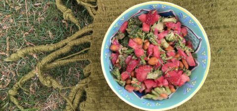 a broccoli and strawberry salad in a bowl.